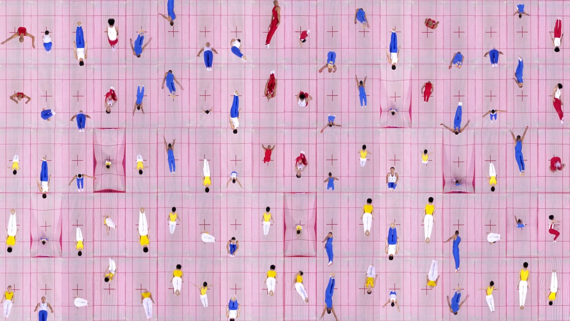 a still from a video artwork of aerial views of people jumping in pink trampolines
