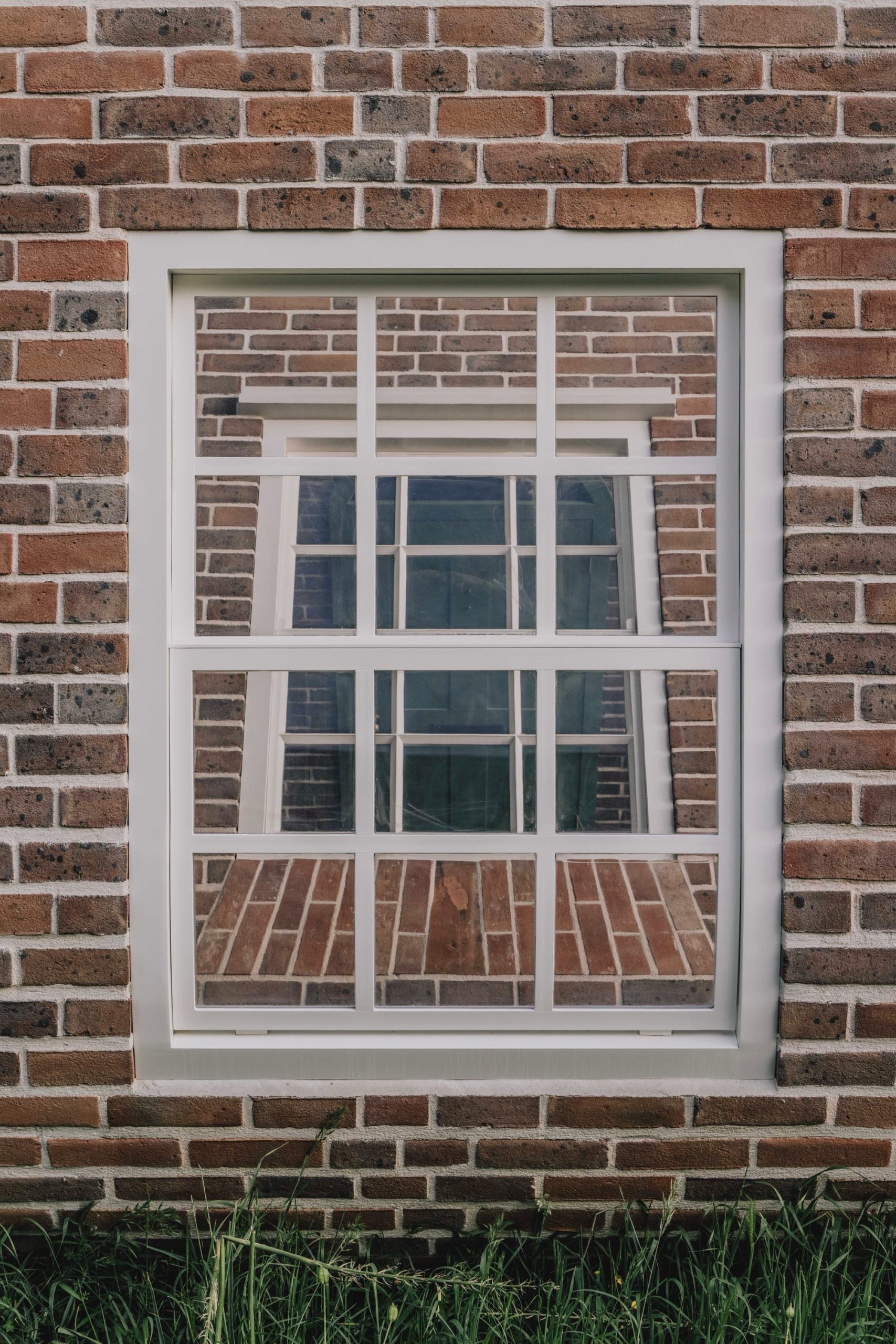 a detail of a public artwork resembling a curving brick townhouse facade
