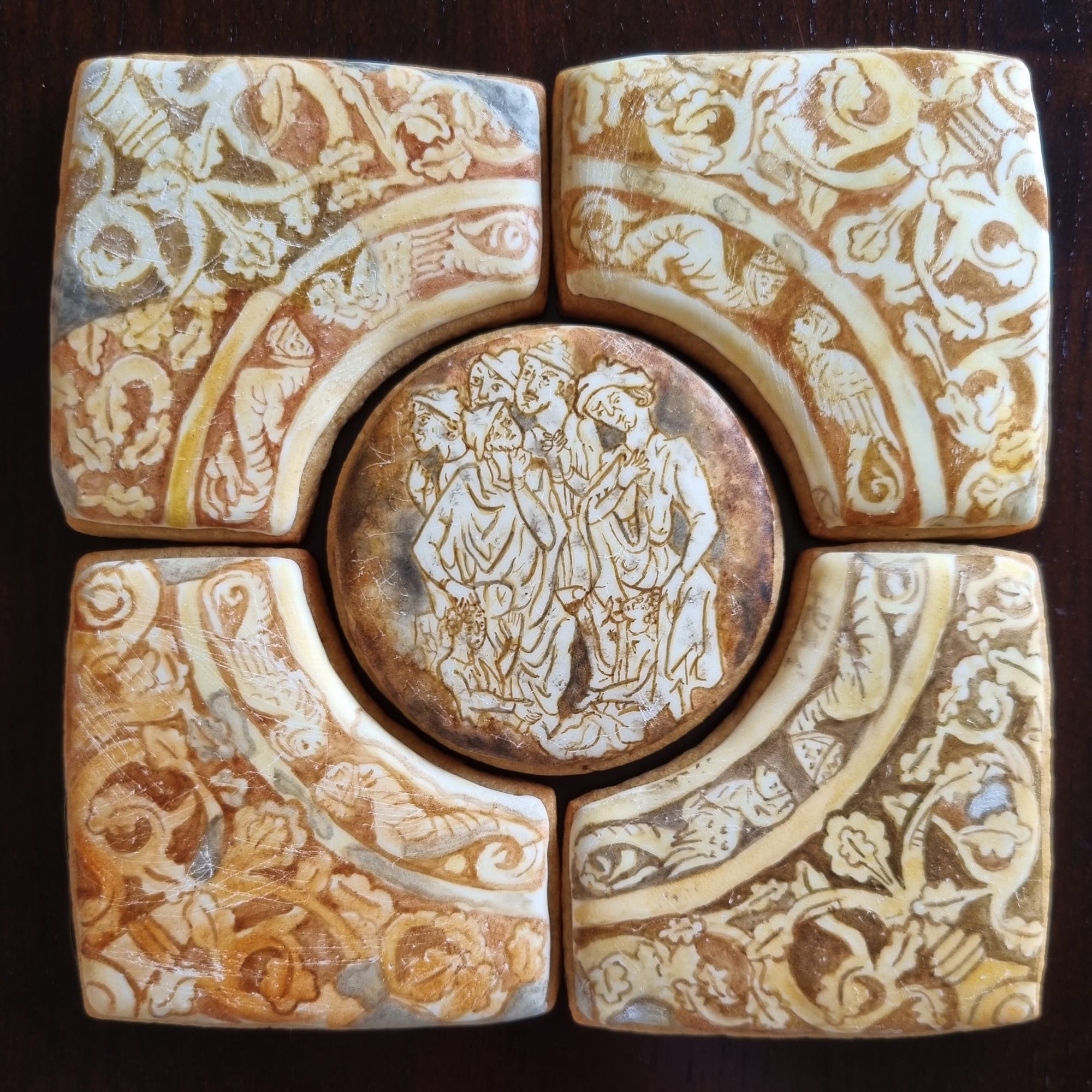 four cookies that looks like antique pottery