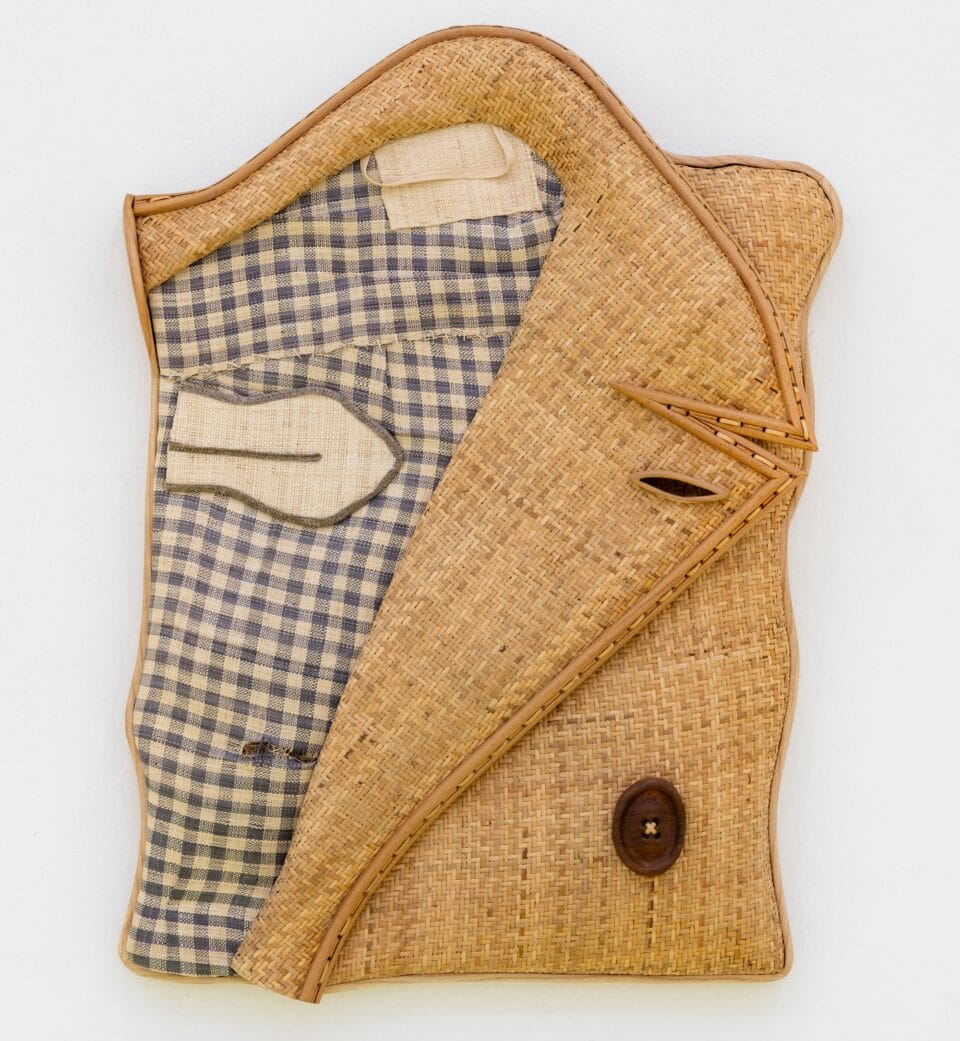 a mixed-media wall sculpture loosely resembling a folded sport jacket