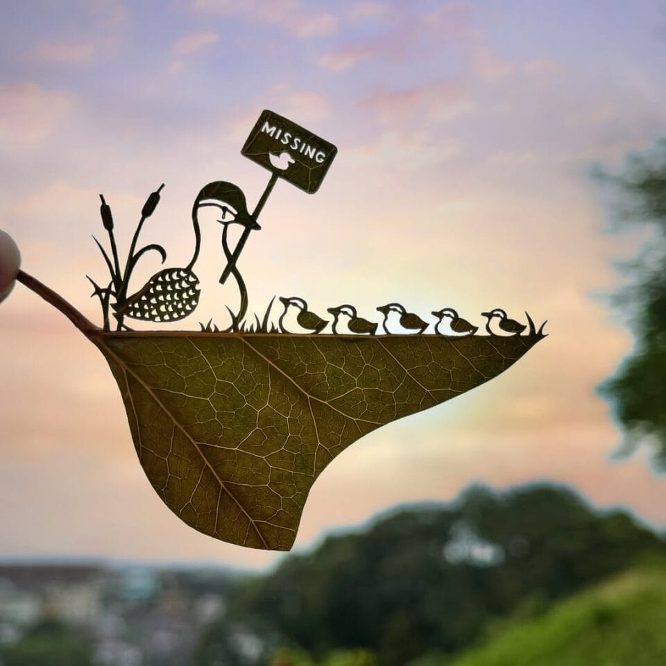 a cut leaf artwork of a duck with her ducklings and a sign reading "missing"